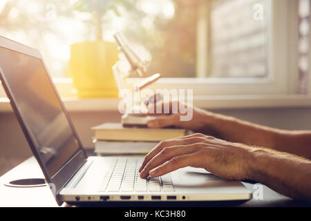science education - new scientist working with laptop and microscope Stock Photo