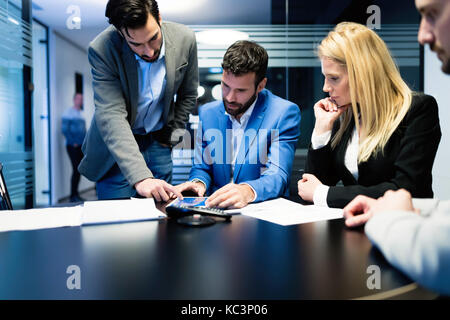 Young businesspeople working on computer in office Stock Photo
