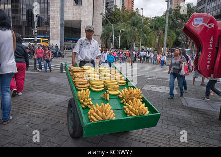 September 26, 2017 Medellin, Colombia: a mobile vendor selling bananas from a wheeled wooden cart in the center of the city Stock Photo