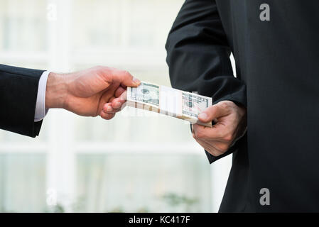 Cropped image of businessman taking bribe from partner outdoors Stock Photo