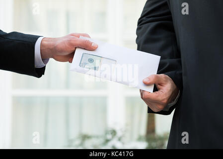 Cropped image of businessman receiving bribe from partner outdoors Stock Photo