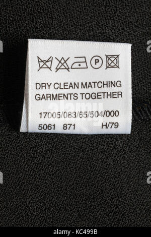 Care washing symbols and instructions on label in woman's clothing - dry clean matching garments together Stock Photo