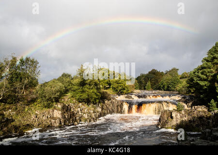 Low Force, Teesdale, County Durham, UK. 2nd Oct, 2017.  UK Weather.  A beautiful rainbow forms over Low Force waterfall on the River Tees as strong winds drive heavy rain showers across Upper Teesdale in County Durham.  Credit: David Forster/Alamy Live News Stock Photo