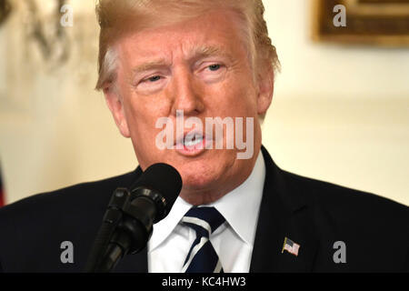 Washington, USA. 02nd Oct, 2017. United States President Donald J. Trump makes remarks on the mass shooting in Las Vegas, Nevada, from the Diplomatic Room at the White House, Washington, DC, October 2, 2017. More than 50 people attending a music festival were killed and hundreds wounded by a gunman. Credit: Mike Theiler/CNP - NO WIRE SERVICE - Credit: Mike Theiler/Consolidated/dpa/Alamy Live News Stock Photo