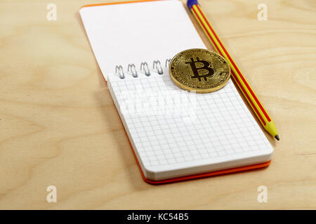 The cryptocurrency bitcoin coin on open notepad.Business concept Stock Photo