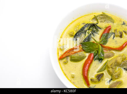 close up green spicy curry soup with chicken is famous thai food menu with chilli herb eggplant and other ingredient for good health Stock Photo