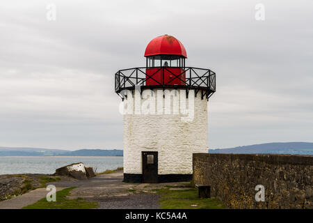 Small white squat white lighthouse with red top. Burry Port, Llanelli, Carmarthenshire, Wales. Stock Photo