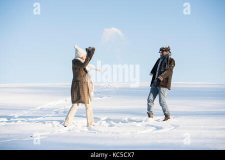 Beautiful senior couple on a walk in sunny winter nature Stock Photo