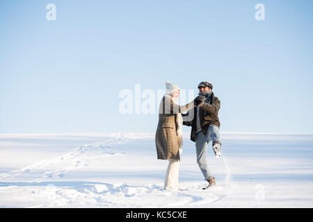 Beautiful senior couple on a walk in sunny winter nature Stock Photo