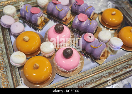 delicious colorful cookies and cakes on the wedding candy bar. Stock Photo