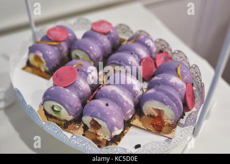 delicious colorful cookies and cakes on the wedding candy bar. Stock Photo