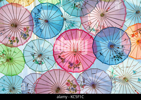 Roof decorated by colorful handmade umbrellas made from paper for protecting sunlight from outside. Stock Photo