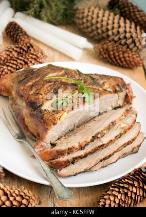 Cold boiled pork is a traditional Russian, Austrian or German dish of meat with spices and garlic. Christmas decoration, rustic style, selective focus Stock Photo