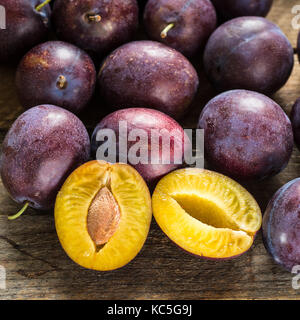 Fresh blue plums on wooden table Stock Photo