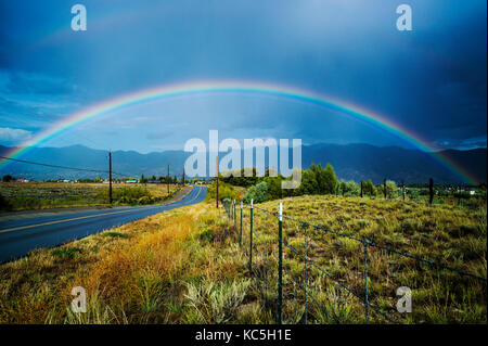 Rainbow over CR 120 & the small mountain town of Salida, Colorado, USA Stock Photo