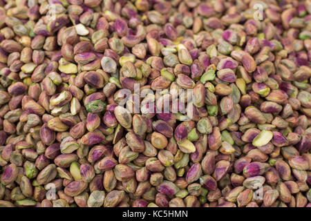 Pistachios nuts pile at the farmers market , natural healthy food ,  Pistachios without shell background Stock Photo