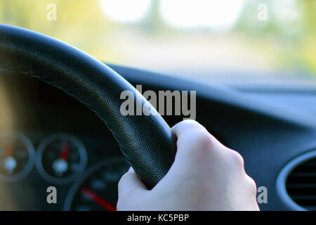 Close up of hand holding car steering wheel. Stock Photo