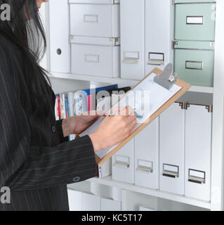 File folders, standing on shelves in the background. Stock Photo