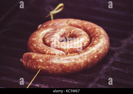 raw sausage links prior to cooking on a hot charcoal grill. fried German sausages. National cuisine. Ingredients - beef hot dog and Burger.