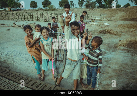 AMRITSAR, PUNJAB, INDIA - 21 APRIL 2017 : picture of Indian kids holding their younger siblings Stock Photo