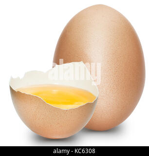 A half egg with the yolk inside with a whole egg on a white background. Stock Photo