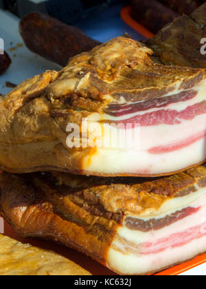Home made smoked bacon in a traditional smoker selective focus and small depth of field. Cholesterol free Stock Photo