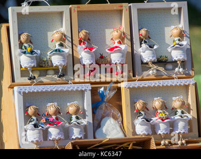 Hand-made wooden dolls on the street sale of souvenirs Stock Photo