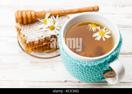 Honeycomb and chamomile tea on white Stock Photo