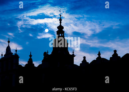 Buildings and roofs silhouetted against a very blue sky, Main Square, Krakow, Poland Stock Photo