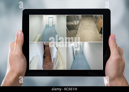 Person Monitoring Cameras Live View Of Home On The Digital Tablet Stock Photo