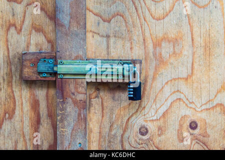 padlock with combination on an old wood door Stock Photo