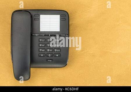 Desk phone on yellow background, close up picture Stock Photo