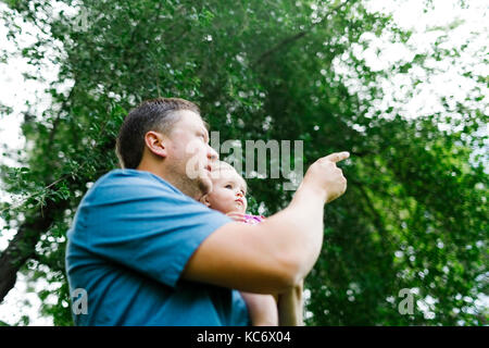 Father playing with baby girl (12-17 months) in backyard Stock Photo