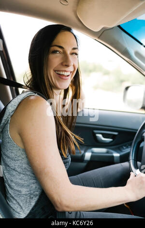 Smiling woman driving car Stock Photo