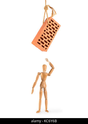 Wooden man with hanging brick threatening him. Isolated on white. Danger, threat, force majeure, disaster and accident concept. Stock Photo