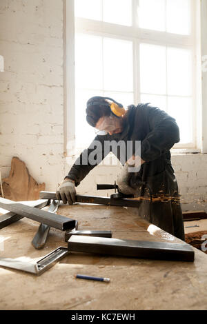 Craftsman making his new project in workshop Stock Photo