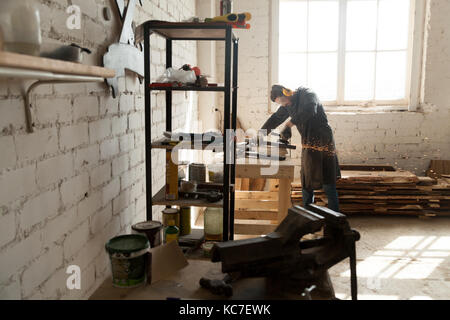 Skilled cabinet maker working in small workshop Stock Photo