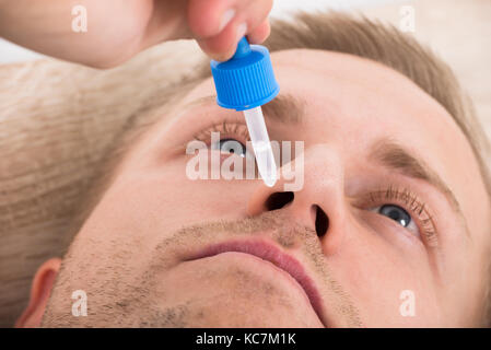 Close-up Photo Of Man Using Nasal Spray Stock Photo