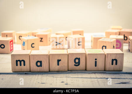 Word ' margin ' wood Cubic on the wood Stock Photo