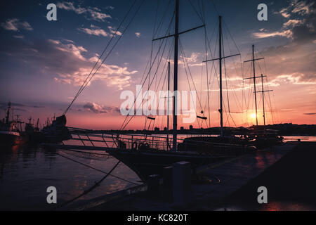 Silhouette photo of sailing ship moored in port of old Nesebar, Bulgaria Stock Photo