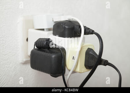 Close up of a overloaded household electrical socket. Stock Photo