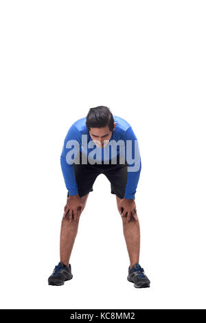 Portrait of tired asian man after running posing isolated over white background Stock Photo