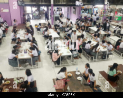 Blur image Canteen Dining Hall Room, A lot of people are eating food in University canteen blur background Stock Photo