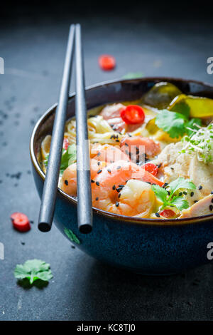 Hot Malaysian Soup with chicken and shrimps Stock Photo