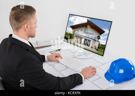 Young Male Architect Working On His Computer In Office Stock Photo