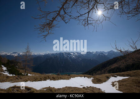 view of lake Achensee and snowy mountain panorama in sun back light, Maurach, Achensee, Austria Stock Photo