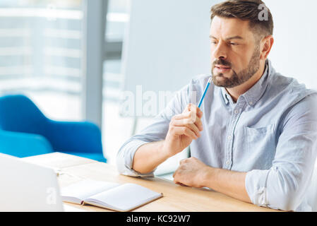 Serious brunette being deep in thoughts Stock Photo