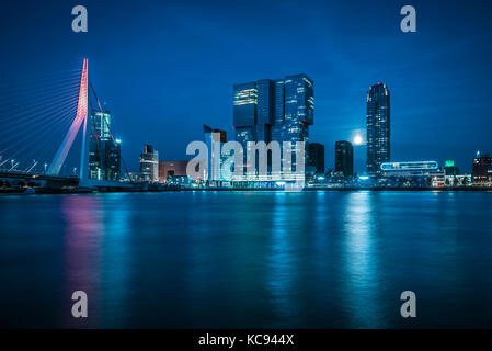 Rotterdam city centre at night with moon. Mass river and Erasmus Bridge Stock Photo