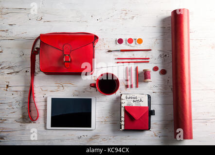 Desk with tablet and school supplies. Studio shot on white wooden background. Stock Photo