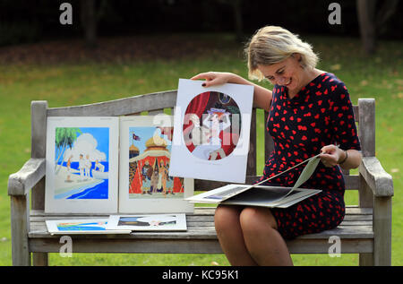 Auctioneer Catherine Southon holds examples from the Smilby cartoon collection, including works that appeared in Playboy, at the Ripley Arts Centre, Bromley, ahead of their auction next month. Stock Photo